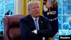 FILE - President Donald Trump speaks during an interview with Reuters at the White House in Washington, Jan. 17, 2018. 