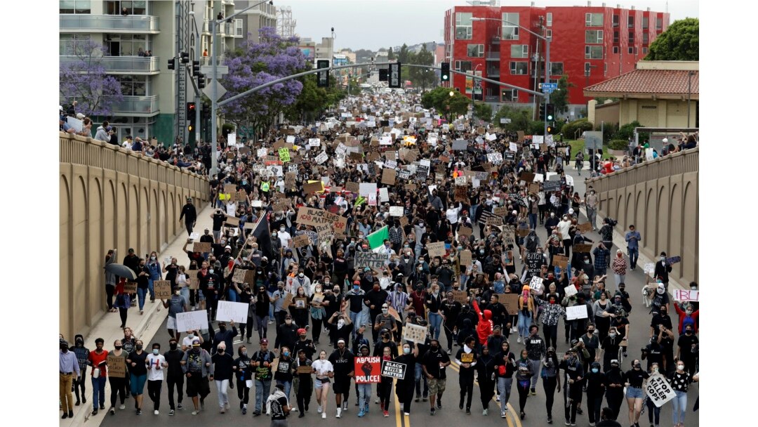 Protestors march Thursday, June 4, 2020, in San Diego. Protests continue to be held in U.S. cities, sparked by the death of George Floyd, a black man who died after being restrained by Minneapolis police officers on May 25.