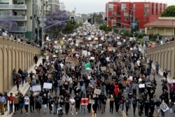 Protestors march Thursday, June 4, 2020, in San Diego. Protests continue to be held in U.S. cities, sparked by the death of George Floyd, a black man who died after being restrained by Minneapolis police officers on May 25.