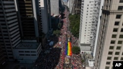 Participants carry a rainbow banner as thousands march in the annual Gay Pride Parade in Sao Paulo, June 2, 2024. 