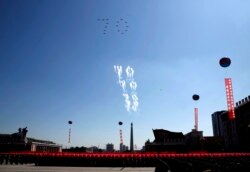 Airplanes forming the number 70 fly in formation and fire flares during a parade for the 70th anniversary of North Korea's founding day in Pyongyang, North Korea, Sept. 9, 2018.