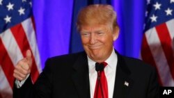 Republican presidential candidate Donald Trump gives a thumbs up during a South Carolina Republican primary night event in Spartanburg, S.C., Feb. 20, 2016. 