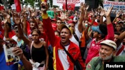 Supporters of Venezuela's President Nicolas Maduro shout as they attend a rally against the application of Organization of American States (OAS) democratic charter, in Caracas, Venezuela, June 23, 2016. 