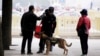 A police dog patrols next to Tiananmen Square on the first day of a plenary session of the 18th Central Committee of the Communist Party of China, in Beijing, China, Oct. 24, 2016.