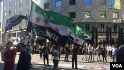 Syrians gather in a Vienna square to inform the public about the gruesome war in Syria, July 3, 2016. Refugees say many people don't realize they had no choice but to flee. (H. Murdock/VOA)