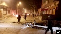 FILE - Tunisian Police officers patrol after clashes in the streets of Kasserine, southern of Tunisia, Dec 25, 2018.