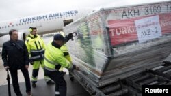 Officials load ballot boxes with votes from expatriates on the constitutional referendum from a truck onto a plane for shipment to Turkey at Tegel airport in Berlin, Germany, April 11, 2017.