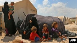 FILE - Displaced Syrians are seen at a camp in Kafr Lusin near the Bab al-Hawa border crossing with Turkey in the northern part of Syria's rebel-held Idlib province, Sept. 6, 2018.