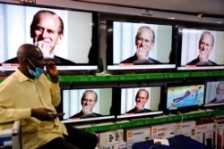 A man watches the news announcing the death of Britain's Prince Philip in a shop in downtown Nairobi, Kenya, April 9, 2021.