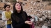 Zeina Rida Jawhari, reacts after recovering a photo of her father from the rubble of her destroyed house in Baalbek, Nov. 28, 2024. 