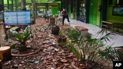 Pieces of roof tiles and other debris litter the ground at a school following an earthquake in Malang, East Java, Indonesia, April 10, 2021. 