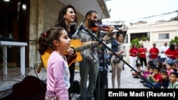 Displaced and refugee children attend an event where Lebanese singer Joy Fayad and musician Oliver Maalouf perform, amid the ongoing hostilities between Hezbollah and Israeli forces, in Dbayeh, Lebanon November 9, 2024. (REUTERS/Emilie Madi)