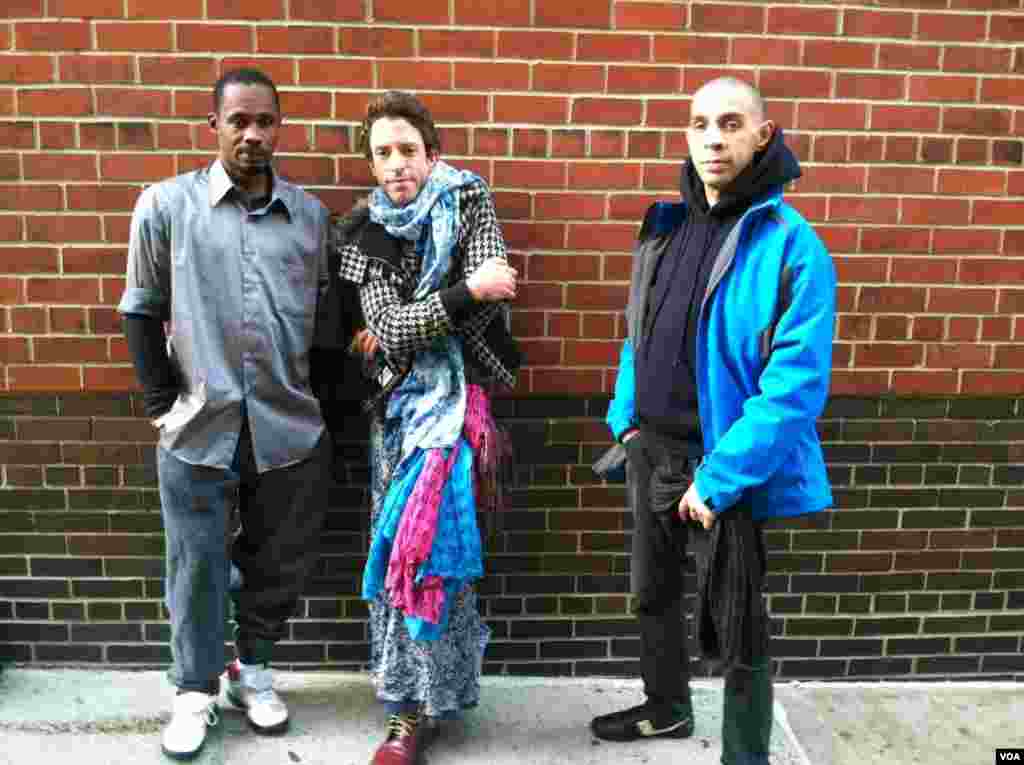 Joseph, Felix and Jeffrey (l to r) have been staying in a temporary shelter since Monday night, when Hurricane Sandy struck. (VOA photo - A. Phillips)