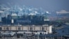 Cargo shipping containers sit on a container ship docked at the Port of Los Angeles on Feb. 3, 2025. China and the U.S. rolled out back-and-forth tariffs over the past two days.