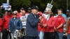 TOPSHOT - US President Joe Biden addresses striking members of the United Auto Workers (UAW) union at a picket line outside a General Motors Service Parts Operations plant in Belleville, Michigan, on September 26, 2023.