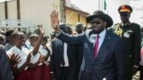 South Sudan President Salva Kiir waves as he greets schoolchildren at Juba International Airport in Juba on Sept. 13, 2018, after returning from the Ethiopian capital Addis Ababa where the latest peace agreement with opposition leader Riek Machar was finalized.