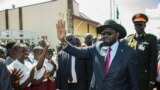 South Sudan President Salva Kiir greets schoolchildren at Juba International Airport on Sept. 13, 2018, after returning from the Ethiopian capital, Addis Ababa. There, the latest peace agreement with opposition leader Riek Machar was finalized.