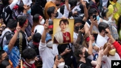 Myanmar nationals living in Thailand hold a picture of former Myanmar leader Aung San Suu Kyi during protest marking the two-year anniversary of the military takeover that ousted her government outside the Myanmar Embassy in Bangkok, Thailand, Feb. 1, 2023. 