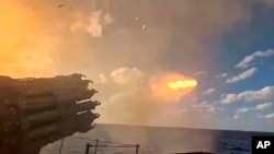 (FILE) This photo taken from video distributed by Russian Defense Ministry Press Service on Sunday, Oct. 13, 2024, a Russian warship fires a missile during joint drills held by the Russian and Chinese navies.