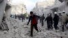 People run on debris at a site hit by what activists said was an airstrike by forces loyal to Syria's President Bashar al-Assad in Aleppo, December 18, 2013.