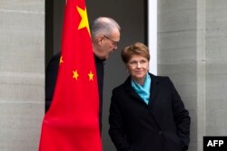 FILE - Swiss President Viola Amherd (R) and Swiss Federal Councillor Guy Parmelin wait for the arrival of Chinese Prime Minister during his official visit in Kehrsatz, on January 15, 2024.