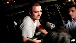 In this July 24, 2018 file photo, Pablo Villavicencio leans out of an SUV while talking to reporters after being released from the Hudson County Correctional Facility in Kearny, N.J. 