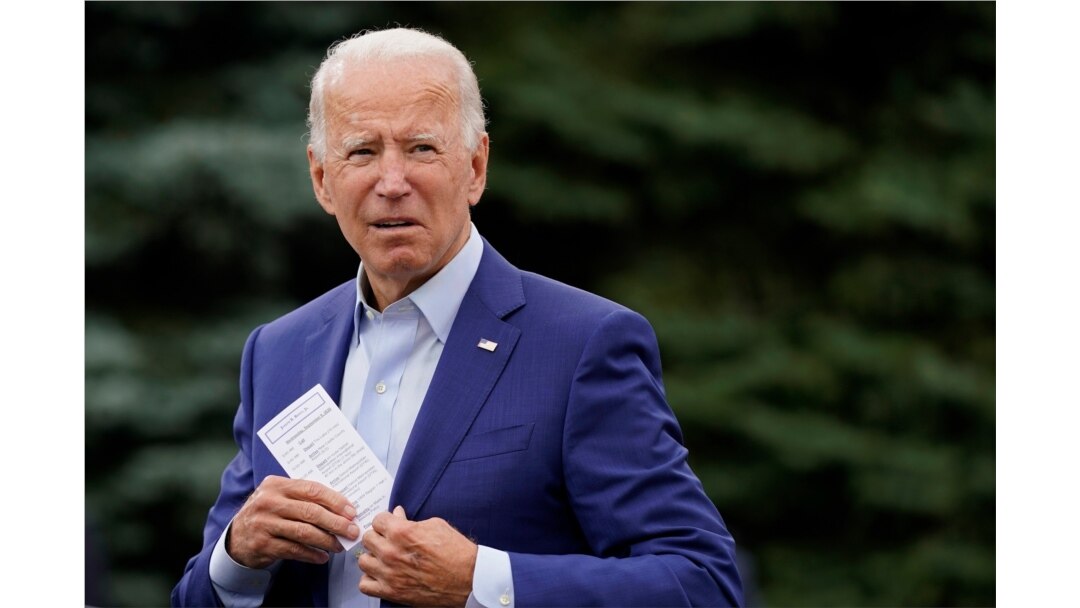 Democratic presidential candidate former Vice President Joe Biden places a note card in his jacket pocket as he speaks at a campaign event in Warren, Mich., Sept. 9, 2020.