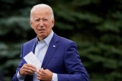 Democratic presidential candidate former Vice President Joe Biden places a note card in his jacket pocket as he speaks at a campaign event in Warren, Mich., Sept. 9, 2020.