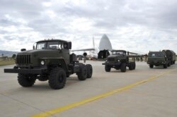 FILE - Military vehicles and equipment, parts of the S-400 air defense systems, are seen on the tarmac, after they were unloaded from a Russian transport aircraft, at Murted military airport in Ankara, July 12, 2019.