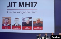 Russian nationals Igor Girkin, Sergey Dubinskiy and Oleg Pulatov, and Ukrainian Leonid Kharchenko, accused of downing of flight MH17, seen on screen as international investigators present their findings, in Nieuwegein, Netherlands, June 19, 2019.