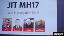 FILE - Russian nationals Igor Girkin, Sergey Dubinskiy and Oleg Pulatov, as well as Ukrainian Leonid Kharchenko, accused of downing of flight MH17, seen on screen as international investigators present their findings in Nieuwegein, June 19, 2019.