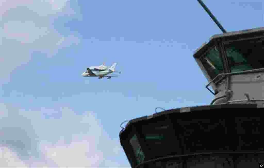 COMMERCIAL IMAGE - In this photograph taken by AP Images for Intrepid Sea, Air & Space Museum, the Space Shuttle Enterprise is seen flying over the Intrepid Sea, Air & Space Museum on Friday, April 27, 2012 in New York. (Ed Rieker/AP Images for Intrepid S