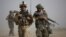 A U.S. Marine and an Afghan soldier are seen on joint patrol in Helmand province, southern Afghanistan (file photo).