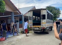 In this photo released by the San Sai District Administrative Office, journalists working for Democratic Voice of Burma prepare to get into a van after being arrested, May 9, 2021.