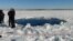 A circular hole in the ice of Chebarkul Lake where a meteor reportedly struck the lake near Chelyabinsk, about 1500 kilometers (930 miles) east of Moscow, Russia, Friday, Feb. 15, 2013. A meteor streaked across the sky and exploded over Russia’s Ural M