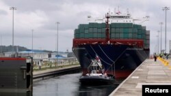 A floating gate is opening to the Chinese COSCO container vessel named Andronikos navigating through the Agua Clara locks during the first ceremonial pass through the newly expanded Panama Canal in Agua Clara, on the outskirts of Colon City, Panama June 2