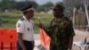 FILE - The spokesperson of the Multinational Security Support Mission for Haiti, General Godfrey Otunge, right, speaks with Haitian National Police general director Rameau Normil, left, in Port-au-Prince, Haiti, Sept. 5, 2024. (Roberto Schmidt/Pool photo via AP)