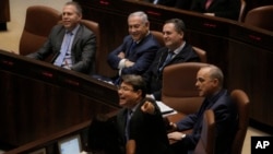 Israeli PM Netanyahu sits with Minister of Public Security Gilad Erdan left, Minister of Transportation Yisrael Katz, Minister of Energy Yuval Steinitz and Minister of Science and Technology Ofir Akunis during a session at the Knesset, March 12, 2018.