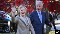 FILE - Then-Democratic presidential candidate Hillary Clinton, and her husband former President Bill Clinton, greet supporters after voting in Chappaqua, N.Y., Nov. 8, 2016. 