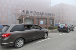 Members of the WHO team investigating the origins of the COVID-19 arrive at the Wuhan Institute of Virology on February 3, 2021.