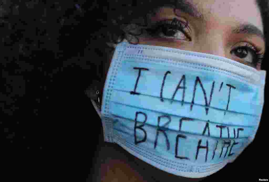 A woman wearing a face mask with the words &quot;I can&#39;t breathe&quot; looks on during a protest in front of a U.S. consulate in Barcelona, Spain, June 1, 2020, against the death in Minneapolis police custody of George Floyd.