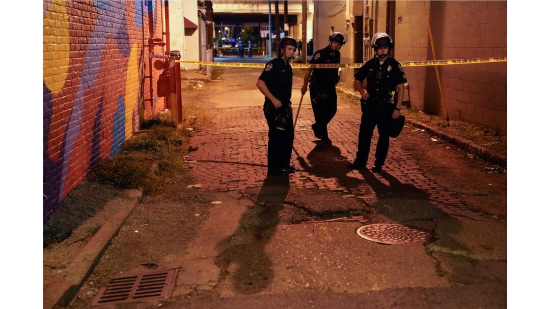 Police survey an area after a police officer was shot, Sept. 23, 2020, in Louisville, Ky. A grand jury has indicted one officer on criminal charges six months after Breonna Taylor was fatally shot by police in Kentucky.