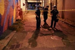 Police survey an area after a police officer was shot, Sept. 23, 2020, in Louisville, Ky. A grand jury has indicted one officer on criminal charges six months after Breonna Taylor was fatally shot by police in Kentucky.