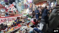 People shop at a market in Tehran on March 12, 2024, as they prepare for Nowruz, the Persian New Year.