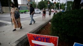 FILE - People wait in a line to vote in the Georgia's primary election at Park Tavern on Tuesday, June 9, 2020, in Atlanta. (AP Photo/Brynn Anderson)