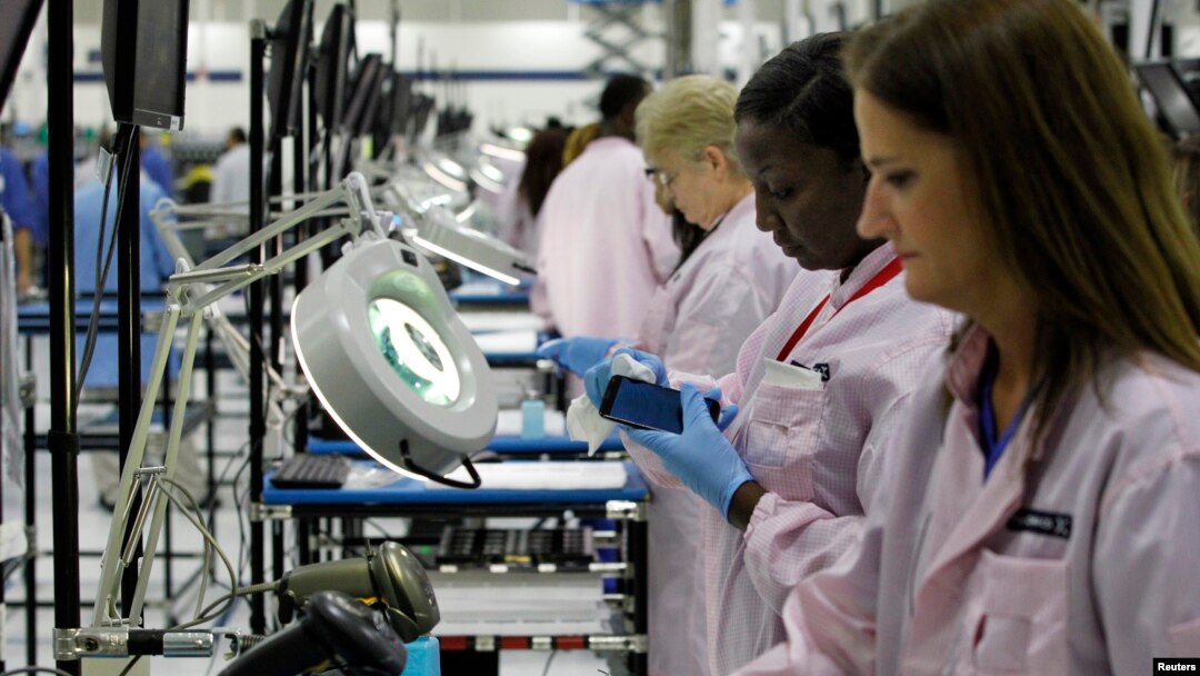 Workers assemble Motorola phones at the Flextronics plant that will be building the new Motorola smart phone "MotoX" in Fort Worth, Texas, Sept. 10, 2013.