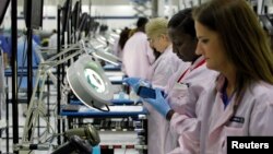 Workers assemble Motorola phones at the Flextronics plant that will be building the new Motorola smart phone "MotoX" in Fort Worth, Texas, Sept. 10, 2013.