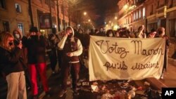 FILE - Demonstrators march with a banner that reads "Vote for Macron, they said," during a rally against police brutality on the Place de La Republique in Paris, Nov. 24, 2020. 