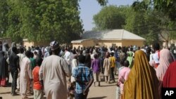 FILE: People gather outside the general hospital where the kidnapped girls from the Government Girls Science and Technical College Dapchi who were released are being treatedd, in Dapchi, Nigeria, March 21, 2018.