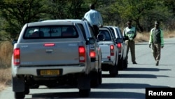 FILE - Zimbabwean policemen are seen stopping a group of cars on the outskirts of Mawabeni, Zimbabwe, June 6, 2008.